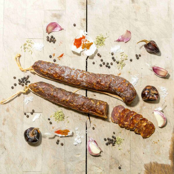 Smoked Chorizo with garlic, peppercorns and chipotle peppers on a board